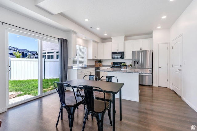 97 E Polaris Dr S Unit 394, Saratoga Springs, UT 84045 - kitchen featuring black appliances, healthy amount of natural light, dark wood finished floors, a center island, and recessed lighting