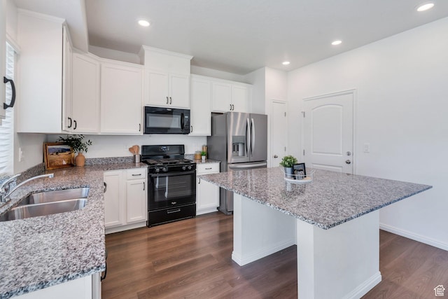 97 E Polaris Dr S Unit 394, Saratoga Springs, UT 84045 - kitchen featuring black appliances, a sink, dark wood-style floors, a kitchen island, and white cabinets