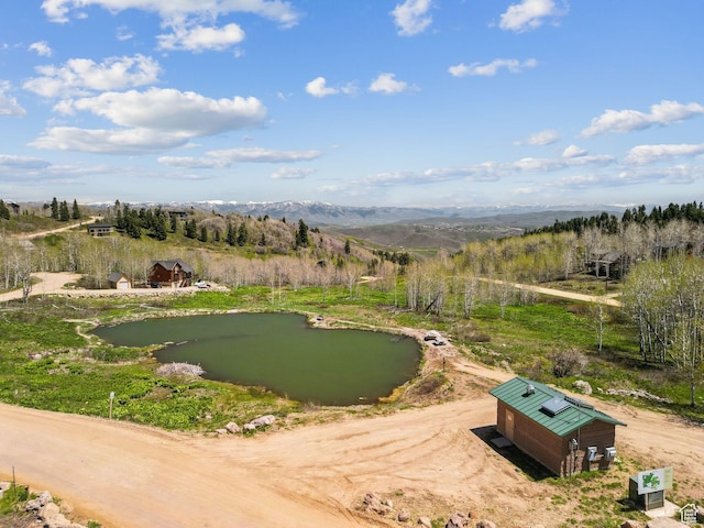 2620 Crow Loop, Coalville, UT 84017 - surrounding community with a water and mountain view, dirt driveway, and a putting area