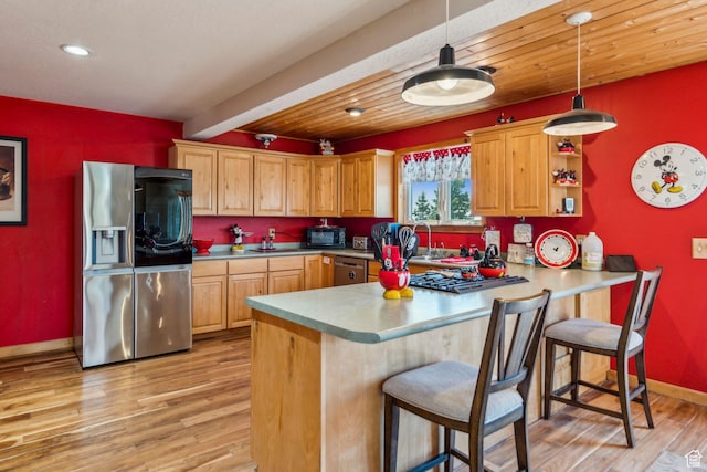 2620 Crow Loop, Coalville, UT 84017 - kitchen with appliances with stainless steel finishes, light wood-style flooring, baseboards, a peninsula, and decorative light fixtures