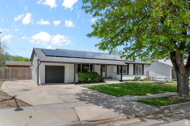 4112 W 5085 S, Kearns, UT 84118 - ranch-style home with an attached garage, covered porch, driveway, and roof mounted solar panels