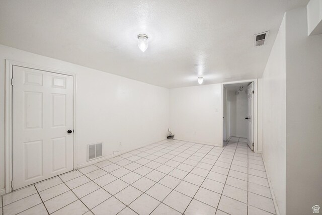 705 N American Beauty Dr, Salt Lake City, UT 84116 - unfurnished room with a textured ceiling, light tile patterned floors, and baseboards