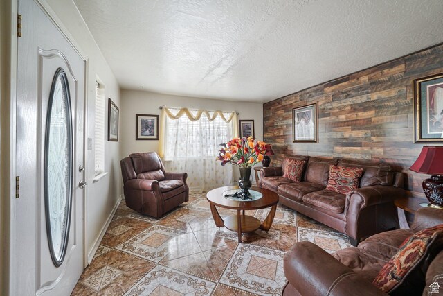 705 N American Beauty Dr, Salt Lake City, UT 84116 - tiled living area featuring wooden walls, a textured ceiling, baseboards, and an accent wall