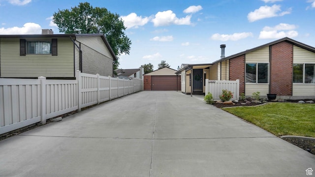 8646 S Spartan Dr, Sandy, UT 84094 - view of home's exterior featuring a detached garage, an outbuilding, and brick siding