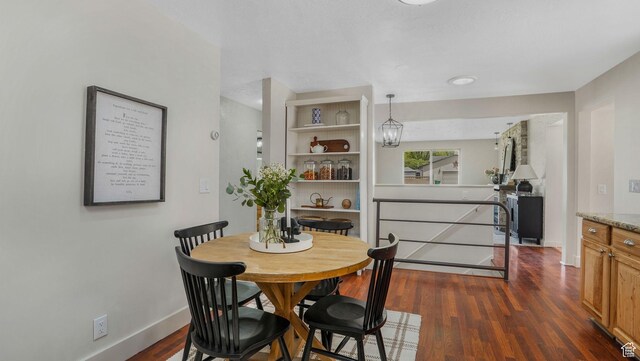 8646 S Spartan Dr, Sandy, UT 84094 - dining room featuring baseboards and dark wood-type flooring