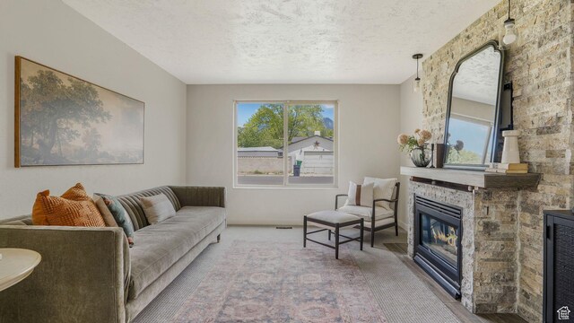 8646 S Spartan Dr, Sandy, UT 84094 - carpeted living room featuring healthy amount of natural light, a textured ceiling, and a stone fireplace