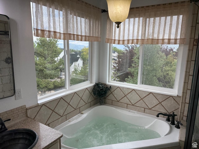 5208 W Case Rd, West Jordan, UT 84081 - full bathroom with a garden tub, backsplash, and vanity