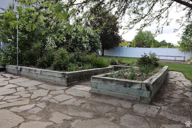5208 W Case Rd, West Jordan, UT 84081 - view of patio featuring a vegetable garden