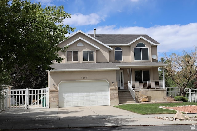 5208 W Case Rd, West Jordan, UT 84081 - traditional-style house featuring stucco siding, concrete driveway, a garage, covered porch, and a shingled roof