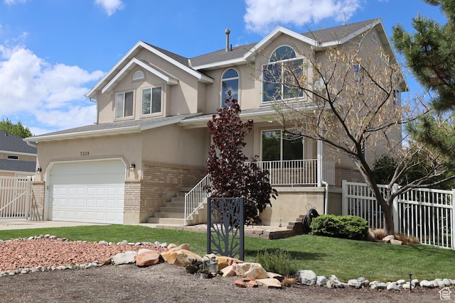 5208 W Case Rd, West Jordan, UT 84081 - traditional-style home featuring brick siding, stucco siding, a porch, and a garage