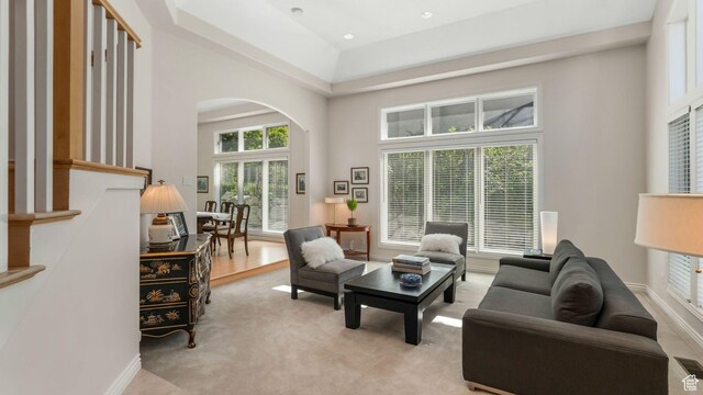 3343 E Stone Mountain Ln, Sandy, UT 84092 - living room featuring arched walkways, light carpet, and a high ceiling