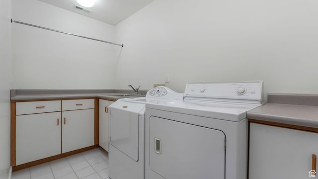 3343 E Stone Mountain Ln, Sandy, UT 84092 - washroom featuring separate washer and dryer, cabinet space, and light tile patterned flooring