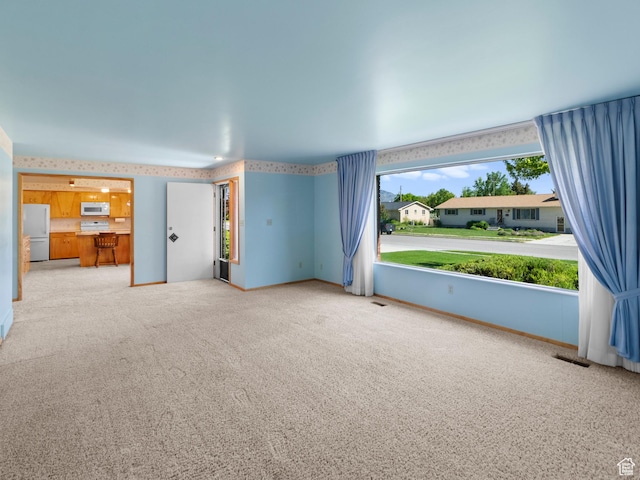 235 E 800 N Unit 2, Tremonton, UT 84337 - unfurnished living room featuring carpet flooring, wallpapered walls, and baseboards
