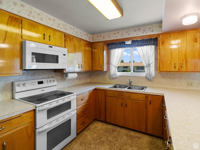 235 E 800 N Unit 2, Tremonton, UT 84337 - kitchen featuring white appliances, a sink, light countertops, and brown cabinetry