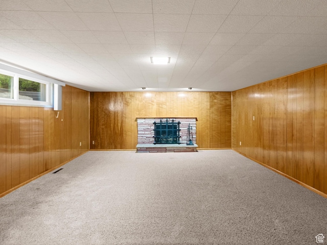 235 E 800 N Unit 2, Tremonton, UT 84337 - below grade area with wooden walls, a fireplace with raised hearth, carpet, and baseboards