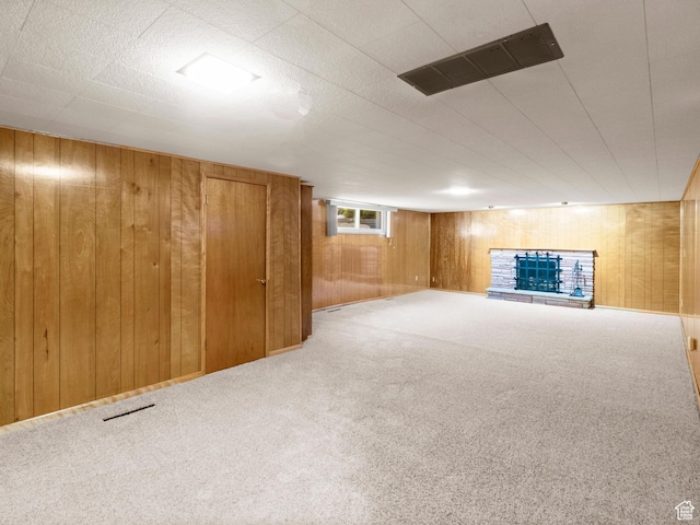 235 E 800 N Unit 2, Tremonton, UT 84337 - below grade area with wood walls, carpet, and a fireplace with raised hearth
