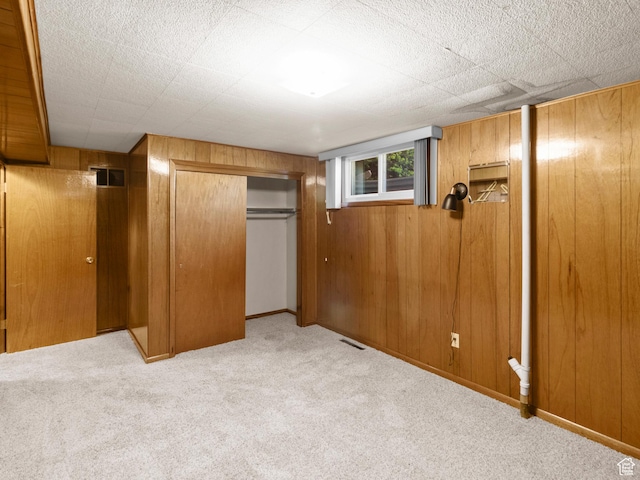 235 E 800 N Unit 2, Tremonton, UT 84337 - unfurnished bedroom with carpet floors, wood walls, and a closet