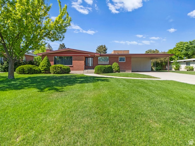 235 E 800 N Unit 2, Tremonton, UT 84337 - single story home with a carport, driveway, brick siding, and a front lawn