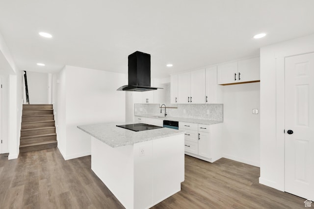 2054 W Mark St, Layton, UT 84041 - kitchen featuring island range hood, black electric cooktop, baseboards, tasteful backsplash, and a sink