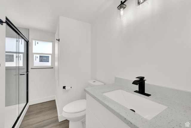 2054 W Mark St, Layton, UT 84041 - full bathroom featuring vanity, toilet, a shower stall, wood finished floors, and baseboards