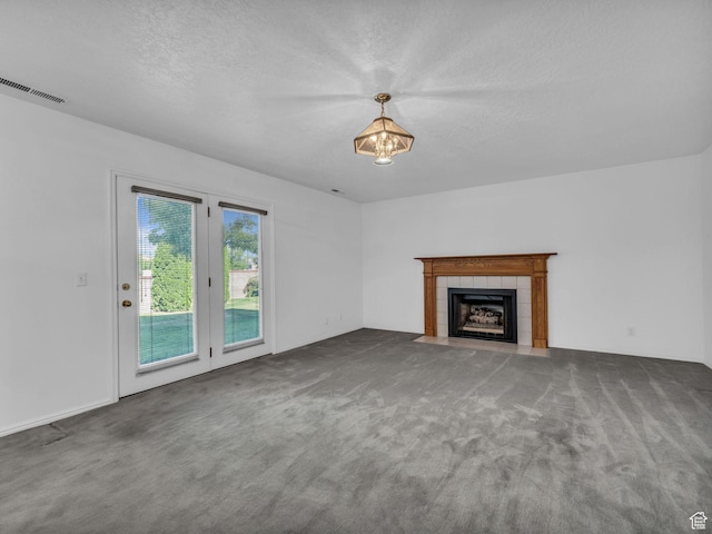 4853 W Ticklegrass Rd, West Jordan, UT 84081 - unfurnished living room featuring carpet, a tile fireplace, and a textured ceiling