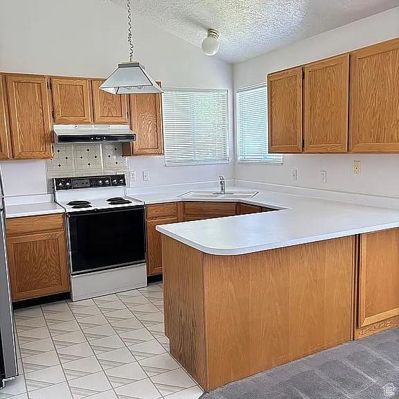 4853 W Ticklegrass Rd, West Jordan, UT 84081 - kitchen with electric range oven, under cabinet range hood, a sink, light countertops, and a peninsula