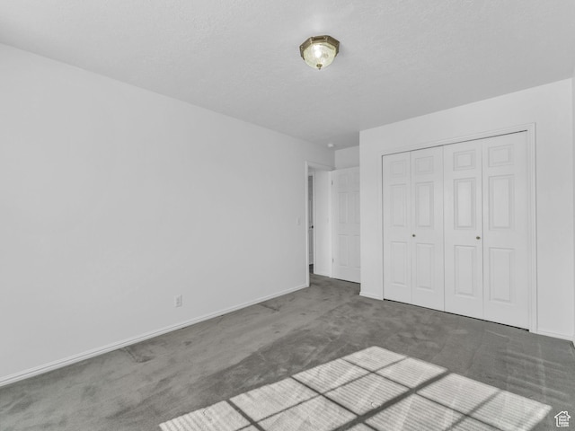 4853 W Ticklegrass Rd, West Jordan, UT 84081 - unfurnished bedroom featuring carpet floors, baseboards, a closet, and a textured ceiling