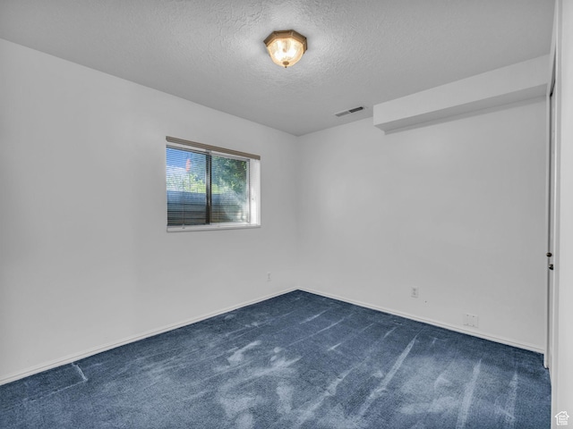 4853 W Ticklegrass Rd, West Jordan, UT 84081 - unfurnished room with a textured ceiling, dark carpet, and baseboards