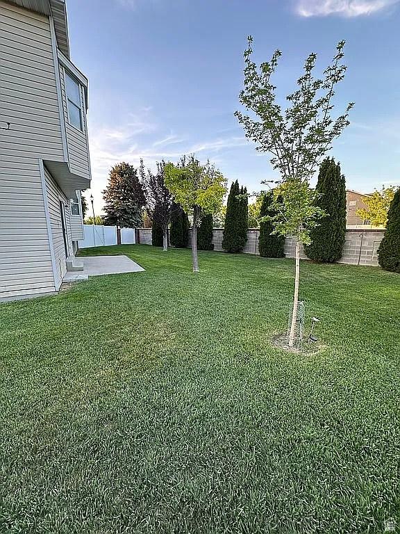 4853 W Ticklegrass Rd, West Jordan, UT 84081 - view of yard with a patio area