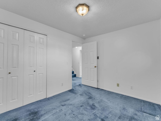 4853 W Ticklegrass Rd, West Jordan, UT 84081 - unfurnished bedroom with carpet floors, a textured ceiling, baseboards, and a closet