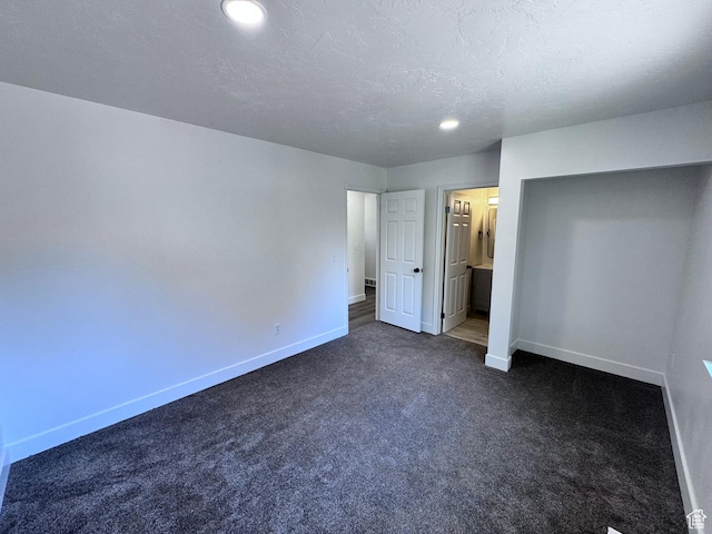 5135 W 4170 S, West Valley City, UT 84120 - unfurnished bedroom featuring baseboards, dark colored carpet, recessed lighting, a textured ceiling, and ensuite bathroom