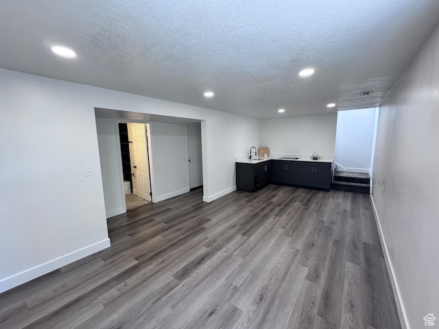 5135 W 4170 S, West Valley City, UT 84120 - basement featuring baseboards, a textured ceiling, recessed lighting, dark wood-style flooring, and bar with sink