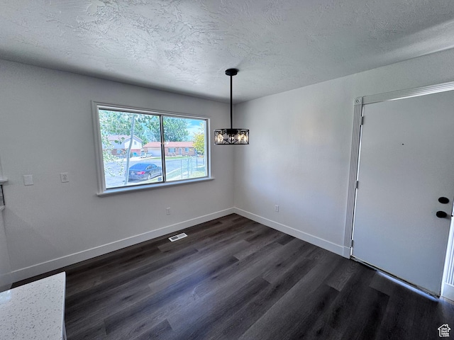 5135 W 4170 S, West Valley City, UT 84120 - unfurnished dining area with dark wood finished floors, a textured ceiling, and baseboards