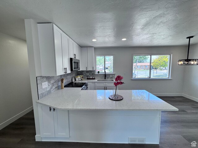 5135 W 4170 S, West Valley City, UT 84120 - kitchen featuring stainless steel microwave, electric range oven, a sink, baseboards, and light stone countertops