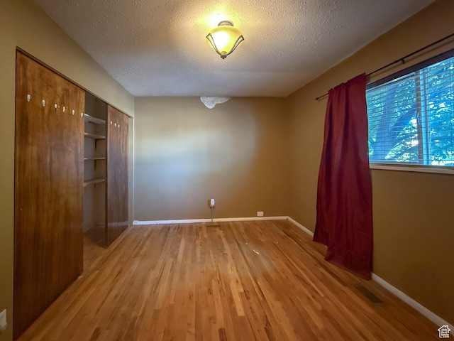 775 N 500 E, Price, UT 84501 - unfurnished bedroom with wood finished floors, baseboards, a textured ceiling, and a closet