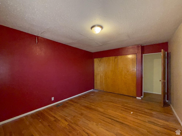 775 N 500 E, Price, UT 84501 - unfurnished bedroom with wood finished floors, a textured ceiling, baseboards, and a closet