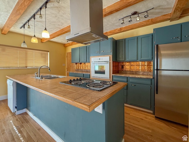 775 N 500 E, Price, UT 84501 - kitchen with freestanding refrigerator, oven, rail lighting, wall chimney range hood, and black electric stovetop