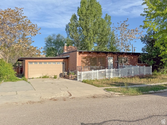 775 N 500 E, Price, UT 84501 - view of front facade featuring a garage, a chimney, and concrete driveway