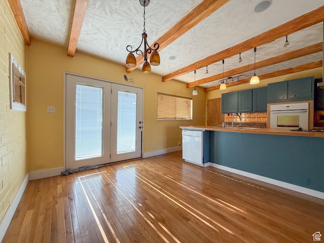 775 N 500 E, Price, UT 84501 - kitchen with white appliances, a chandelier, beamed ceiling, hardwood / wood-style flooring, and pendant lighting