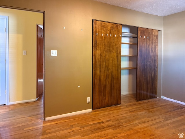 775 N 500 E, Price, UT 84501 - unfurnished bedroom with wood finished floors, baseboards, and a textured ceiling