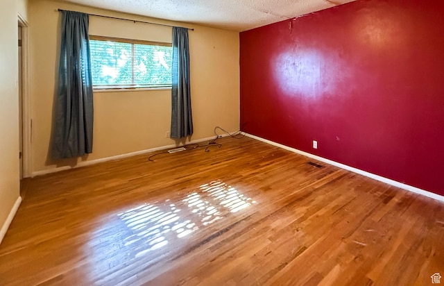 775 N 500 E, Price, UT 84501 - spare room featuring wood finished floors, a textured ceiling, and baseboards
