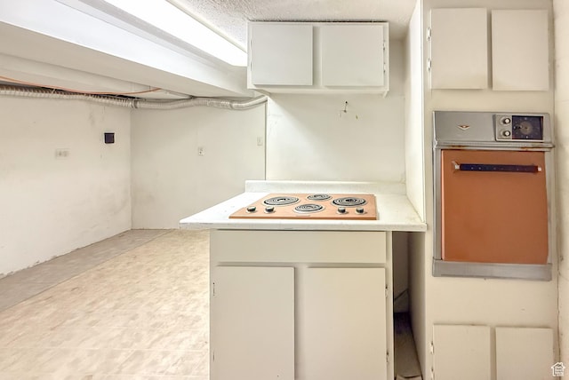 775 N 500 E, Price, UT 84501 - kitchen with wall oven, white electric cooktop, light countertops, and white cabinetry