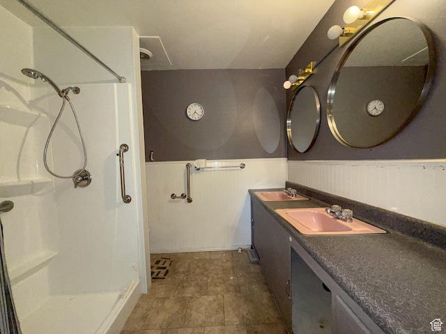 775 N 500 E, Price, UT 84501 - bathroom featuring walk in shower, double vanity, and a wainscoted wall