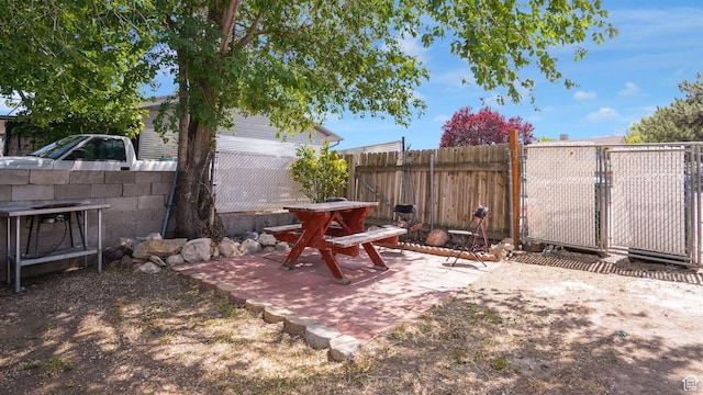 6828 W Copperhill Dr, West Valley City, UT 84128 - fenced yard featuring a patio