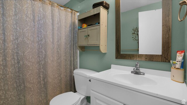 6828 W Copperhill Dr, West Valley City, UT 84128 - bathroom with toilet, vanity, and curtained shower
