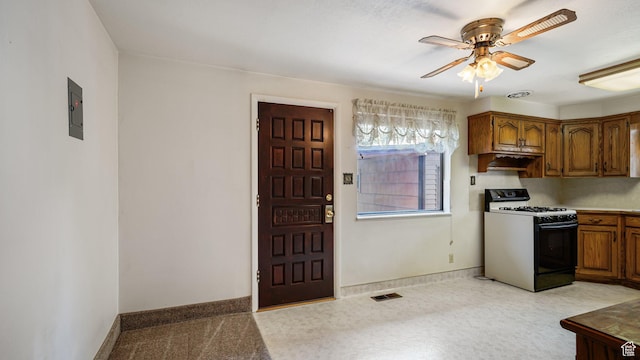 374 N 500 E, Spanish Fork, UT 84660 - kitchen featuring gas stove, a ceiling fan, brown cabinets, and baseboards