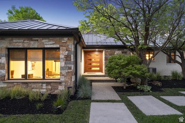 2067 E Pheasant Cir, Holladay, UT 84121 - view of front of house featuring a standing seam roof, stone siding, and metal roof