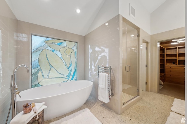 2067 E Pheasant Cir, Holladay, UT 84121 - bathroom with radiator, a shower stall, lofted ceiling, a soaking tub, and speckled floor