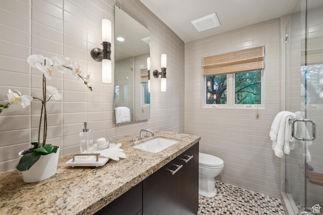 2067 E Pheasant Cir, Holladay, UT 84121 - full bathroom featuring tile walls, vanity, a stall shower, and toilet