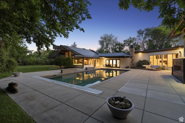 2067 E Pheasant Cir, Holladay, UT 84121 - pool at dusk with an outdoor hangout area, a patio area, an outdoor pool, and a yard